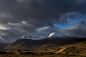 Snowy mountain peaks of Meall aÂ´Bhuiridh and Clach Leathad in the background and dramatic clouds