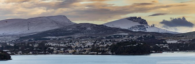 Portree in winter at sunrise with Old man of Storr and Bergen in the background