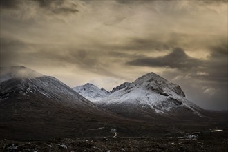 Snowy mountain tops of Ben Lee with clouds in Highland landscape