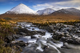 AltDearg Mor with snow-covered peaks of the Cullins Mountains in Highland landscape