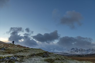 Photographer in Highland landscape with winter Cullins mountains