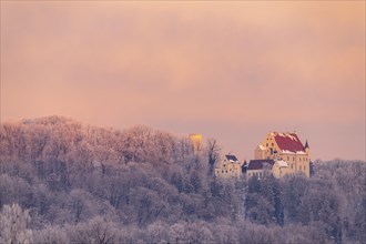 Mindelburg Castle in winter forest at sunrise