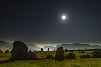 Stone circle at full moon with starry sky