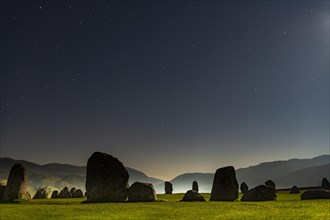 Stone circle at full moon with starry sky