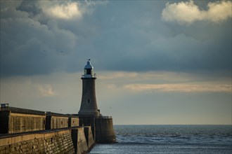 Lighthouse with harbour wall