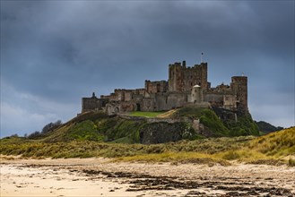 Sandy coast at low tide with Bamburgh Castle