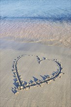 Heart paintet in sand