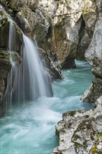 Waterfall on the emerald green wild river Soca