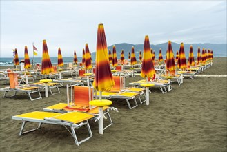 Folded sunshades and beach chairs