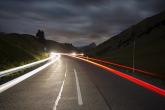 Pass road at night with light streaks from cars on Hochtannbergpass