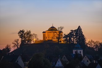 Illuminated burial chapel Rotenberg on the mountain Wurttemberg at dusk