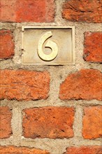 Old golden house number plate