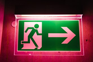 Red illuminated emergency exit sign