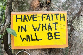 Sign posted on tree saying Have Faith In What Will Be