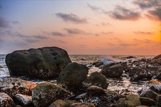 Sunset at rocky coast near Long Beach in Sok San village on Koh Rong island