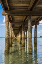 Pier on beach with turquoise water at Saracen Bay on Koh Rong Sanloem island