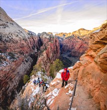 Young woman hikes on the via ferrata descending from Angels Landing