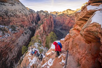 Young woman hikes on the via ferrata descending from Angels Landing
