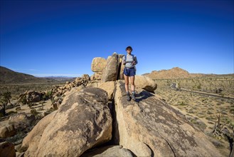 Young woman on boulder