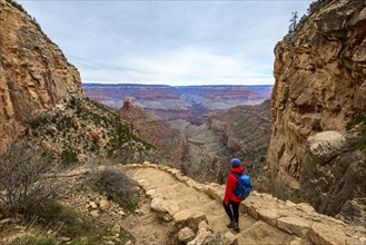 Young woman descending on footpath down into Grand Canyon