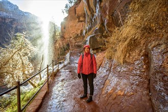 Female hiker in front of waterfall