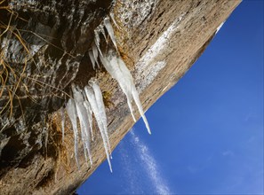 Icicles hanging on rock face