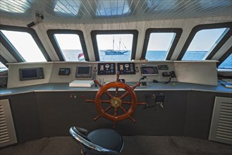 Navigation bridge with view of sailing ship