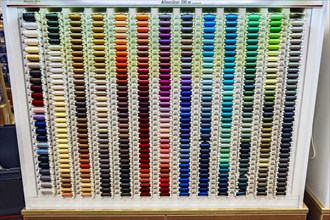 Colorful spools with sewing thread in many colors in a department store