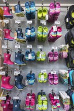 Children's clogs and rubber boots in hardware store