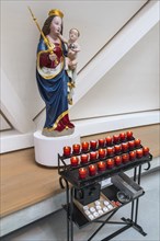 Madonna figure with baby Jesus and sacrificial candles