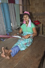 Woman with neck rings weaving