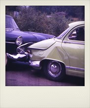 Old Polaroid photograph of crash vintage cars