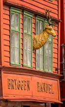 Golden deer figure on the wall of a historic wooden house