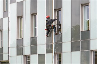 Window cleaner on skyscraper facade