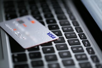 Visa credit card on a keyboard of a computer