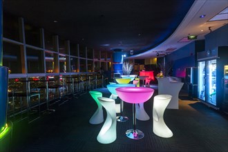 Illuminated chairs and tables in a discotheque