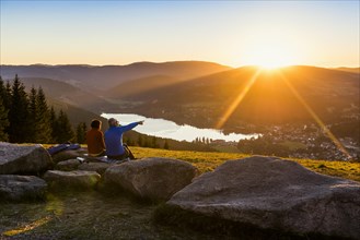 Older couple at Hochfirst with view to Titisee and Feldberg at sunset