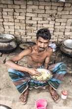 Worker eating rice