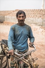 Portrait of a worker with a rickshaw