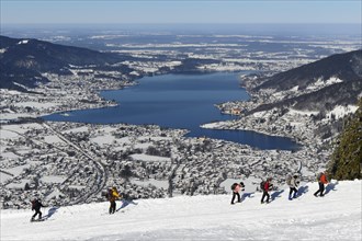 Hikers and ski tourers climb the Wallberg in winter