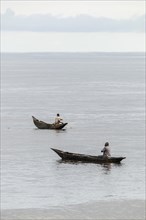 Fisherman in dugout canoes