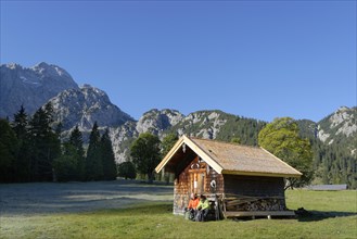 Hikers resting wooden hut
