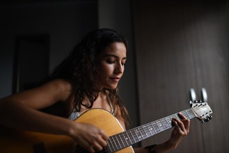 Female singer and songwriter La Lovo with guitar