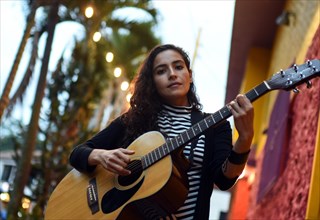 Female singer and songwriter La Lovo with guitar