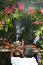Shaman leading Maya ritual with burning copal resin at Tres Reyes Maya village