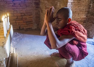 Novice monk praying