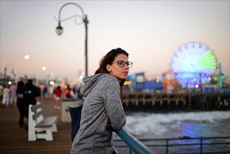 Attractive young woman relaxing on pier