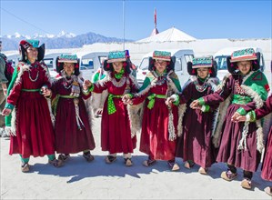 Ladakhi people with traditional costumes dancing