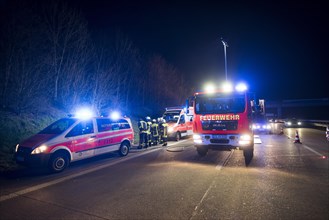 Emergency vehicles in an accident on the highway at night