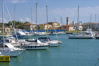 Sailing and motor boats are anchored in the harbour
